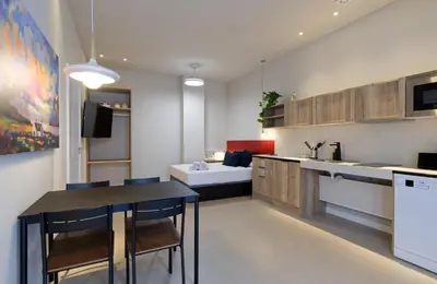 a kitchen with a table and chairs in a room at Osito Hub - Colomer in Valencia