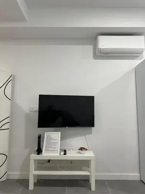 a white room with a tv on a wall at Alojamiento,Hospedaje centrico en valencia in Valencia