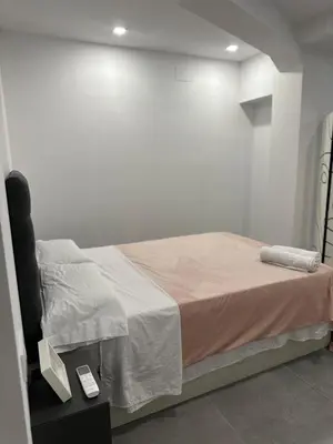 a bed in a room with a white wall at Alojamiento,Hospedaje centrico en valencia in Valencia
