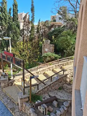 a set of stairs with a street sign on it at Faro Playa de Cullera in Faro de Cullera