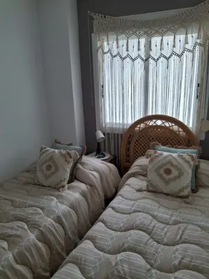 two beds sitting next to each other in a bedroom at Faro Playa de Cullera in Faro de Cullera