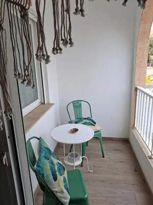 a small table and chairs in a room with a window at Faro Playa de Cullera in Faro de Cullera