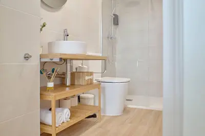 a bathroom with a sink and a toilet and a shower at Romantic Suite Roig Arena N1 Virkin Suites in Valencia