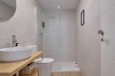 a bathroom with a sink and a toilet and a shower at Romantic Suite Roig Arena N1 Virkin Suites in Valencia