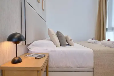 a bedroom with two beds and a table with a lamp at Romantic Suite Roig Arena N1 Virkin Suites in Valencia