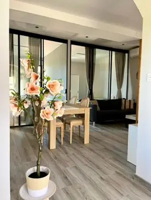 a living room with a table and a vase with flowers at Elegante apartamento boutique a 5 min del metro in Bétera