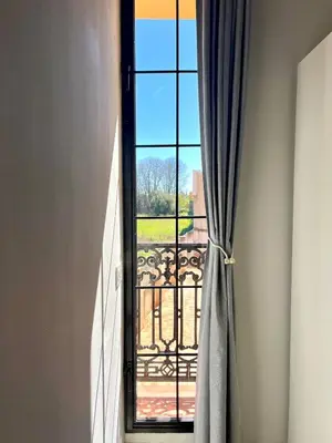 a window with a view of a balcony at Elegante apartamento boutique a 5 min del metro in Bétera