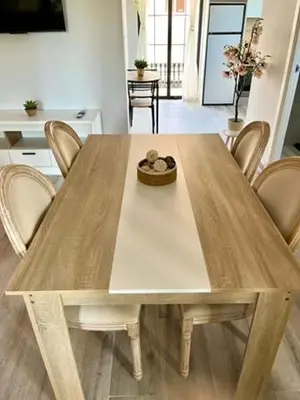 a wooden table with chairs and a bowl on top at Elegante apartamento boutique a 5 min del metro in Bétera