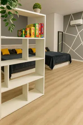 a room with a bed and shelves with books at Alojamiento, hospedaje para 6 personas in Valencia