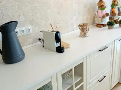 a kitchen counter with a white counter top with a radio at Casa El Azud La Cañada 1 minuto metro in Partida de La Cañada