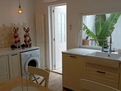 a kitchen with a sink and a washing machine at Casa El Azud La Cañada 1 minuto metro in Partida de La Cañada