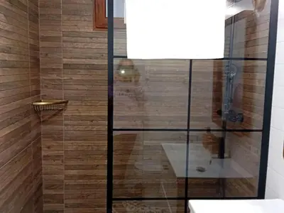 a shower with a glass partition in a bathroom at Casa El Azud La Cañada 1 minuto metro in Partida de La Cañada