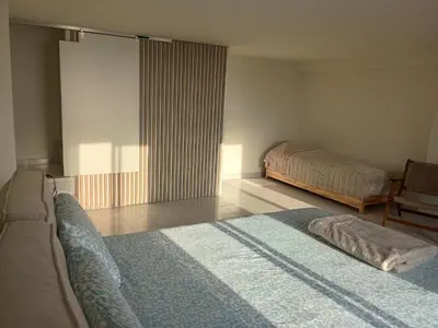 a bedroom with two beds and a window in it at LOFT ROYAL - apartamento 
