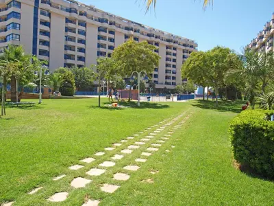 a walkway in a park in front of a building at ApartUP Patacona Iconic II in Valencia