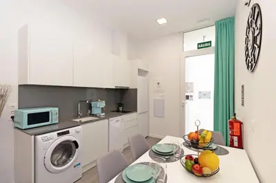 a kitchen with a table with a bowl of fruit on it at GuestReady - Llovera apartments in Valencia