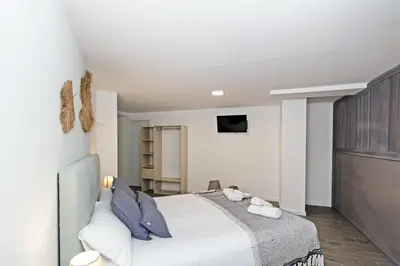 a bedroom with a large white bed with blue pillows at GuestReady - Llovera apartments in Valencia
