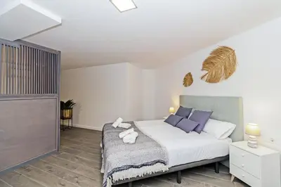 a bedroom with a large bed with purple pillows at GuestReady - Llovera apartments in Valencia