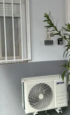 a white air conditioner on a wall next to a window at Mi refugio en la playa in Moncófar