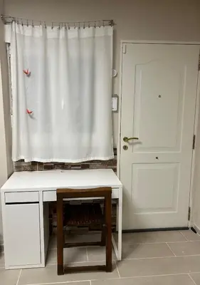 a white desk in front of a window with a door at Mi refugio en la playa in Moncófar