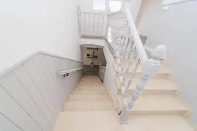 a white staircase with a white stair case at Luxury villa 20 minutes from Valencia in Lliria