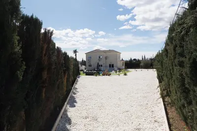 a view of a beach with a house in the background at Luxury villa 20 minutes from Valencia in Lliria