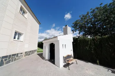 a bench sitting in front of a building at Luxury villa 20 minutes from Valencia in Lliria