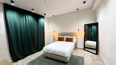 a bedroom with a large bed and a mirror at Beach Room Valencia, NETFLIX, 4 mins walk to the beach in Valencia