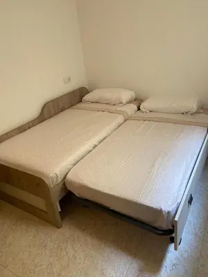 two twin beds in a room with at Apartamento playa de chilches in Chilches