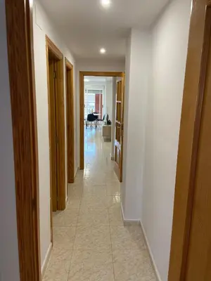 a hallway of a house with white walls and a room at Apartamento playa de chilches in Chilches