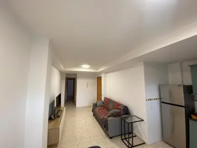 a living room with a couch and a refrigerator at Apartamento playa de chilches in Chilches