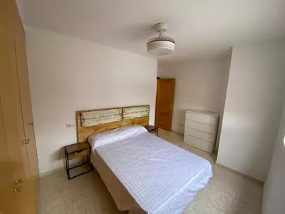 a bedroom with a bed in a white room at Apartamento playa de chilches in Chilches
