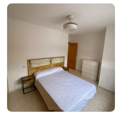 a bedroom with a bed in a white room at Apartamento playa de chilches in Chilches