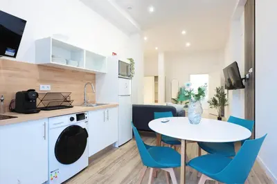a kitchen and dining room with a table and chairs at Total Valencia Sorolla in Valencia