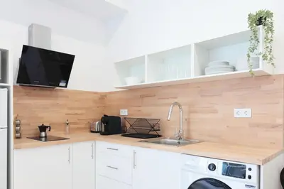 a kitchen with white cabinets and a sink at Total Valencia Sorolla in Valencia