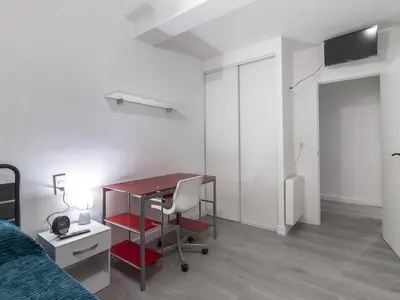 a bedroom with a desk and a bed and a desk and a chair at Winahost Paterna Palisses in Paterna