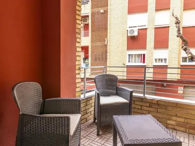 a patio with chairs and a table and a window at Winahost Paterna Palisses in Paterna