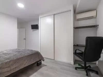 a bedroom with a bed and a desk and a chair at Winahost Paterna Palisses in Paterna