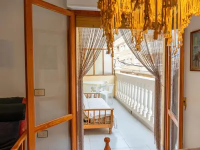 a room with a glass door and a chandelier at Apartamento Pinzón in Moncófar