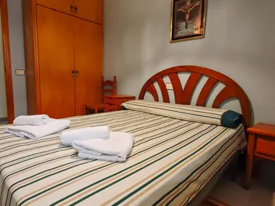 a bedroom with a bed with two towels on it at Apartamento Pinzón in Moncófar