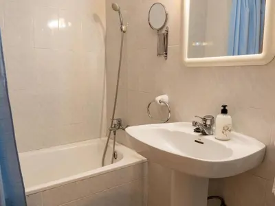 a white bathroom with a sink and a shower at Apartamento Pinzón in Moncófar
