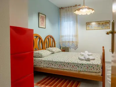 a bedroom with a bed with a teddy bear on it at Apartamento Pinzón in Moncófar