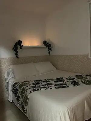 a bed with a black and white blanket on it at Playa sol y arena in Valencia