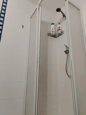a bathroom with a shower with two bottles on a shelf at Playa sol y arena in Valencia