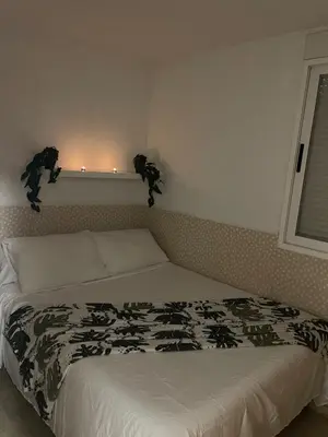 a bedroom with a white bed with lights on the wall at Playa sol y arena in Valencia