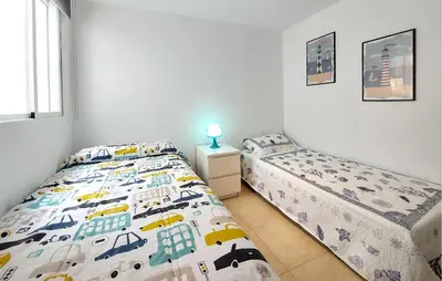a bedroom with two twin beds and a window at 2 Bedroom Awesome Apartment In Moncofa in Moncófar