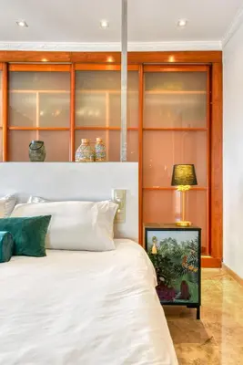 a bedroom with a bed and a table with a lamp at Villa near Valencia 17PAX, Pool, Cinema, BBQ, KidsRoom in Manises