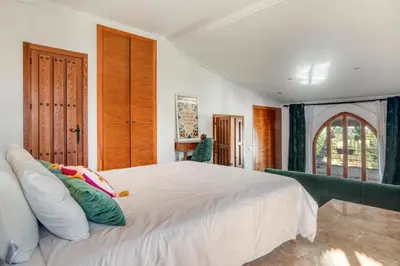 a bedroom with a large white bed and a window at Villa near Valencia 17PAX, Pool, Cinema, BBQ, KidsRoom in Manises