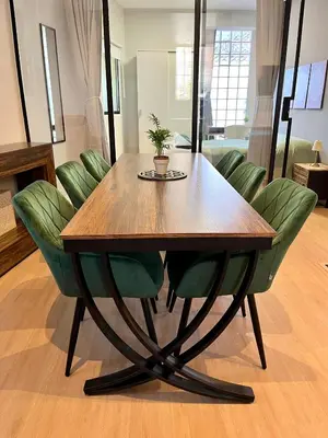 a wooden table with green chairs around it at Encantador apartamento boutique a 5 min del metro in Bétera