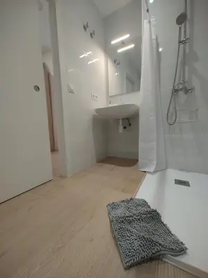 a white bathroom with a sink and a mirror at New central flat with AC and Wifi in Valencia
