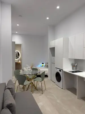 a kitchen and living room with a table and chairs at MAGNO- Beach in Valencia